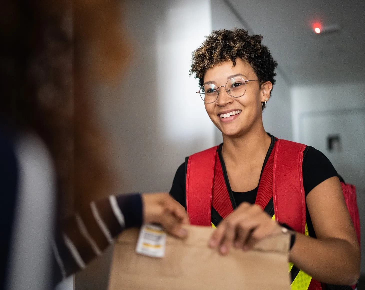 Delivery rider handing a package to a customer