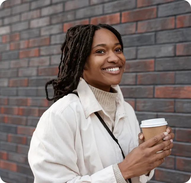 Smiling woman standing in brick room