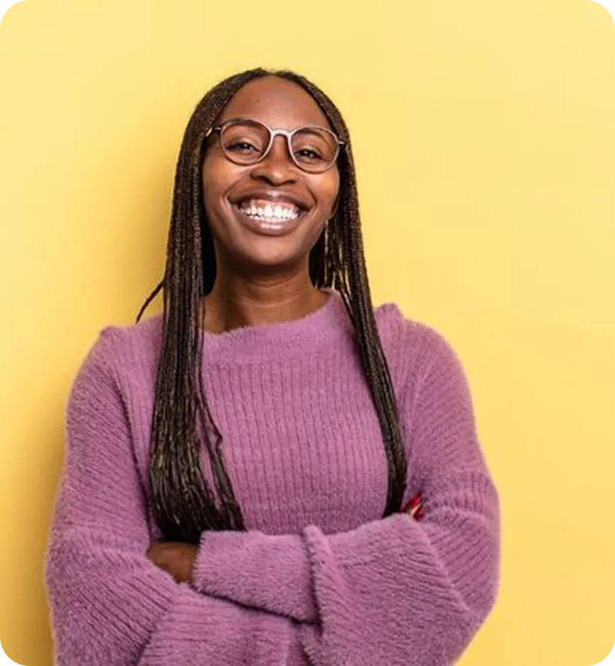 Woman smiling widely in front of yellow background