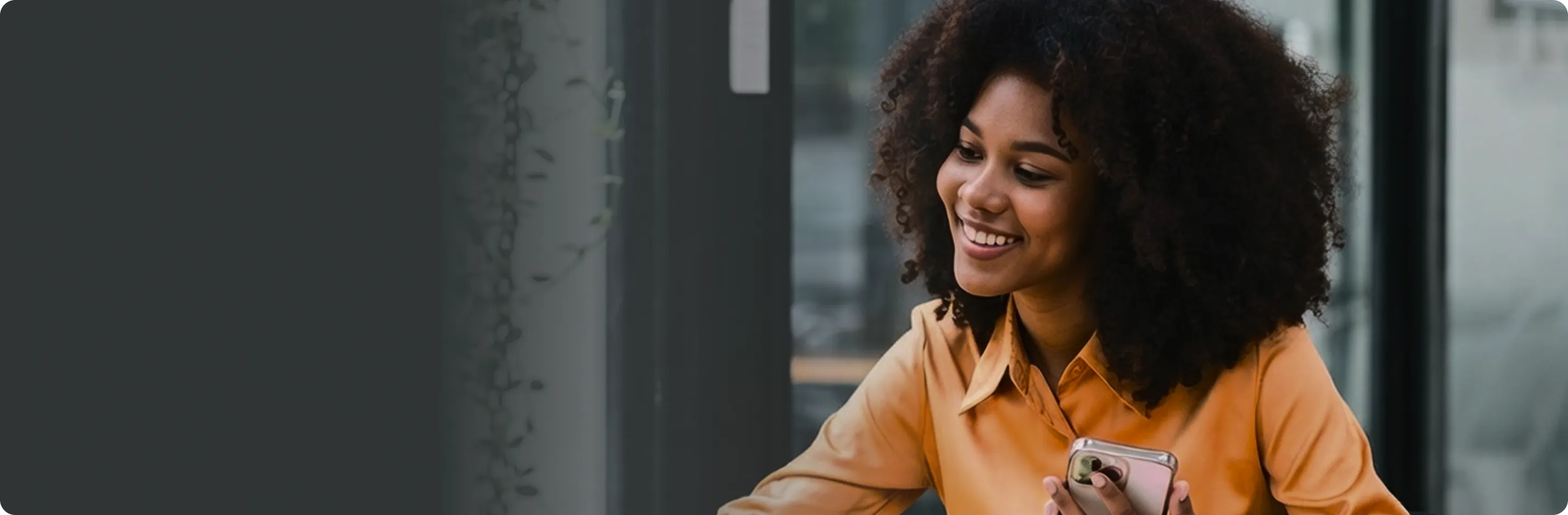 Woman smiling while holding smartphone